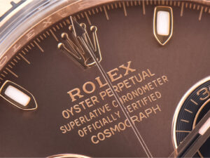 Close-up of Cosmograph Daytona Rose Gold with Chocolate Dial, showcasing the logo and inscription on the elegant dial.