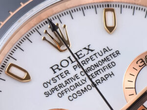 Close-up view of the Cosmograph Daytona Rose Gold Oysterflex watch featuring ivory dial with gold accents, precise markings.
