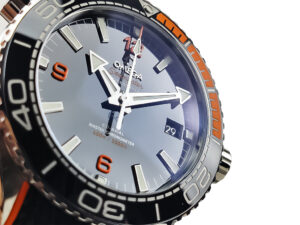 Seamaster Planet Ocean 600 watch with a blue dial, bold numerals, and orange accents on a rubber strap (43.5mm).