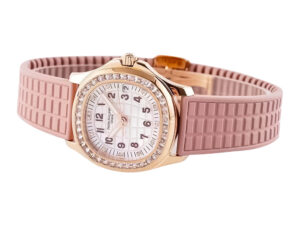 Rose gold diamond-encrusted watch with a pink textured strap, featuring a white dial and luminous markers.