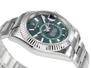 Sky-Dweller Stainless Steel watch with Oyster bracelet, green dial, and fluted bezel displayed at an angle.