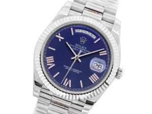 Day-Date 40 White Gold 'President' watch with blue dial, Roman numerals, fluted bezel, and day-date display.