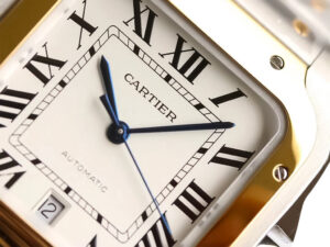 Close-up of the Santos Large Two Tone Yellow Gold with White Dial (40mm), showcasing Roman numerals and blue steel hands.