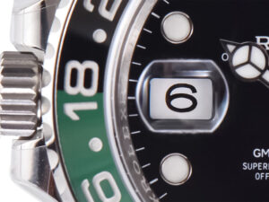 Close-up of the GMT-Master II Stainless Steel ‘Sprite’ on Oyster (40mm), featuring a black and green bezel and date display.