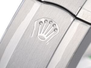 Close-up of the stainless steel clasp on the Oyster Perpetual 41, featuring an engraved crown logo on a polished surface.