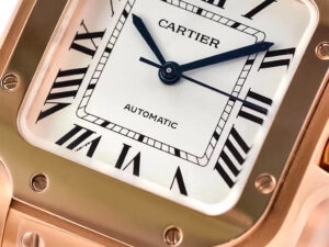 Close-up of the Santos Medium Rose Gold watch with a white dial, black Roman numerals, blue steel hands, automatic movement.