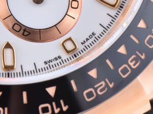 Close-up of the Cosmograph Daytona in rose gold with an ivory dial, showcasing the bezel and "Swiss Made" marking.