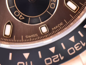Close-up of the Cosmograph Daytona Rose Gold Oysterflex watch, featuring a chocolate dial with "Swiss Made" engraving.