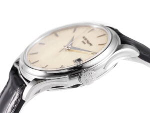 Close-up of the Calatrava Stainless Steel watch with ivory dial (39mm) and a black leather strap, showcasing elegant details.