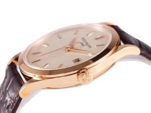 Side view of the Calatrava Rose Gold with Ivory Dial (38mm) featuring a brown leather strap and engraved crown detail.