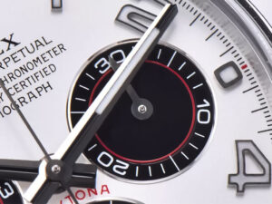 Close-up of the Cosmograph Daytona Stainless Steel watch with white dial, Arabic numerals, and detailed sub-dial design.