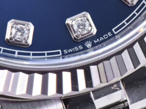 Close-up of Datejust 36 Stainless Steel on Jubilee bracelet showcasing the Diamond Blue Dial, Fluted Bezel, "Swiss Made" .