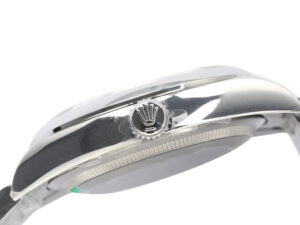 Side view of the Oyster Perpetual 36 Stainless Steel watch, showcasing the polished casing and crown detail with logo.