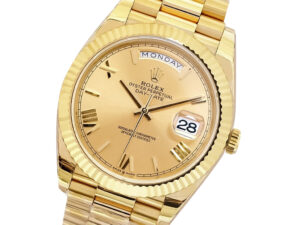 Day-Date 40 Yellow Gold 'President' watch with Champagne Dial, Roman Numerals, and Fluted Bezel displaying Monday and date.