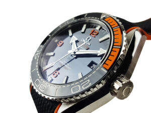 Seamaster Planet Ocean 600, 43.5mm with blue dial, orange accents, and rubber strap displayed at an angled close-up view.
