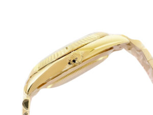 Side view of the Day-Date 40 Yellow Gold ‘President’ watch with fluted bezel and signature black motif dial.