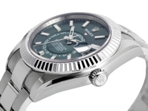 Sky-Dweller Stainless Steel watch with green dial, fluted bezel, and Oyster bracelet displayed at an angled close-up view.