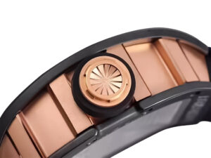 Side view of the RM 52-01 Skull watch showcasing its rose gold bezel, black crown with intricate design, black rubber strap.