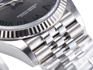 Close-up of Datejust 36 Stainless Steel ‘Wimbledon’ on Jubilee bracelet with fluted bezel and green Roman numeral dial.
