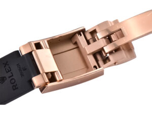 Close-up view of the clasp mechanism of the Cosmograph Daytona Rose Gold Oysterflex watch with detailed rose gold finish.