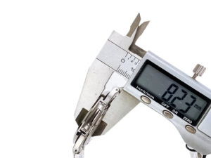 Close-up of a caliper measuring the thickness of the Nautilus Stainless Steel with Green Dial (40mm) watch at 8.27 mm.