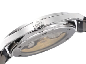 Side profile view of Calatrava Stainless Steel watch with an engraved crown, showcasing polished finish and intricate back.