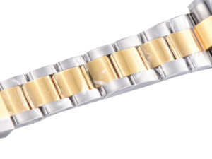 Close-up of the Cosmograph Daytona Two Tone Yellow Gold & Steel bracelet showcasing its polished metal links.