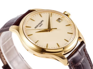 Calatrava Yellow Gold watch with an ivory dial, 39mm case, brown leather strap, and date display at 3 o'clock.
