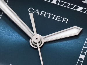 Close-up of the Santos Large Stainless Steel watch's blue dial, showcasing sleek silver hands and Cartier logo.