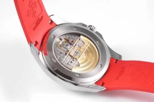 Back view of the Aquanaut Stainless Steel 'Singapore' watch; visible movement through  caseback, red rubber strap attached.