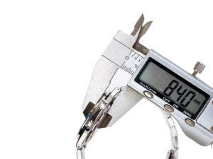 Caliper measuring the 8.47mm thickness of the Nautilus Stainless Steel with Green Dial and Diamond Bezel (40mm) watch band.