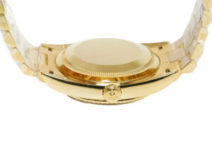 Day-Date 36 Stainless Steel ‘President’ watch with silver dial, diamond bezel, and close-up of gold case back and crown.