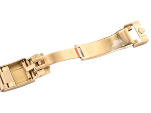 Close-up of the yellow gold clasp of the Cosmograph Daytona 'Paul Newman' watch, showcasing intricate detailing.