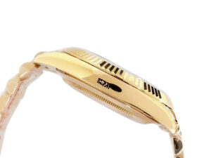 Side view of the Day-Date 40 Yellow Gold ‘President’ watch with fluted bezel and green dial featuring Roman numerals.