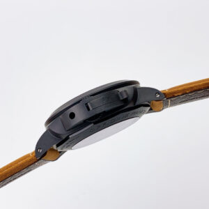Side profile of the Luminor 1950 3 Days GMT Automatic Ceramica watch with a black case and brown strap, showcasing design.
