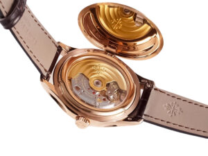 Back view of the Calatrava Rose Gold watch (39mm) showcasing its ivory leather strap and intricate open-case back mechanics.