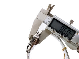 Close-up of a caliper measuring the thickness of the Nautilus Stainless Steel with White Dial (40mm) watch, showing 8.60 mm.