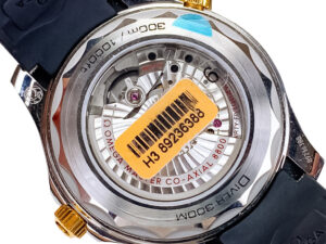 Back view of the Seamaster Diver 300, showcasing its open case back with visible movement, gold accents, and rubber strap.