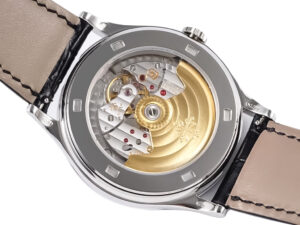 Back view of the Calatrava Stainless Steel, showcasing mechanical movement through a transparent case back and beige strap.