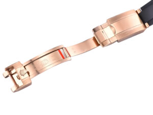 Rose gold Oysterflex clasp of the Cosmograph Daytona with a sleek black strap, showcasing luxurious craftsmanship.