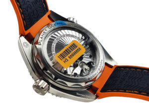 Back view of the Seamaster Planet Ocean 600 with Blue Dial on Rubber Strap, showcasing its transparent case back movement.