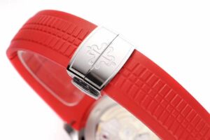 Close-up of the Aquanaut Stainless Steel 'Singapore' with a red rubber strap, stainless steel clasp, and intricate detailing.
