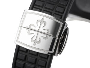 Close-up of the clasp on the black textured strap of the Aquanaut Luce Stainless Steel Diamond Black watch, engraved logo.