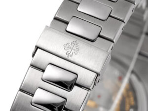 Close-up of the stainless steel bracelet clasp of the Nautilus Moonphase watch, featuring an engraved emblem.