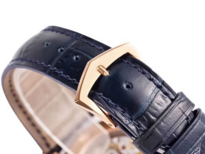 Close-up of Calatrava Rose Gold watch's blue alligator leather strap with rose gold buckle, highlighting its elegant design.