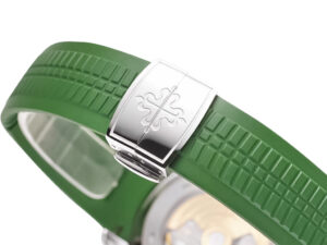 Close-up of the Aquanaut Stainless Steel 'Jumbo' watch clasp and green rubber strap, showcasing intricate design details.
