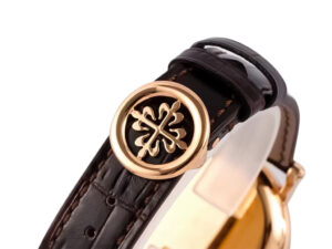 Calatrava Rose Gold watch with a silver guilloche dial, displayed close-up showcasing black leather strap and clasp detail.