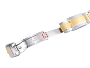 Close-up of the clasp mechanism for Cosmograph Daytona Two Tone Yellow Gold & Steel watch, showcasing steel and gold details.