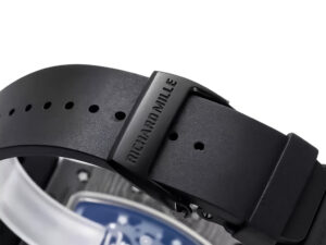 Close-up view of the black rubber strap and buckle with "RICHARD MILLE" engraving on the RM055 Bubba Watson watch.