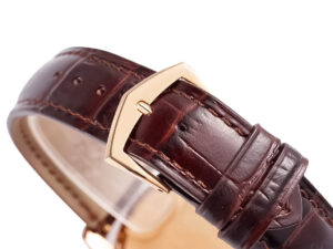 Close-up of the Calatrava Rose Gold watch's brown leather strap with a polished rose gold buckle.